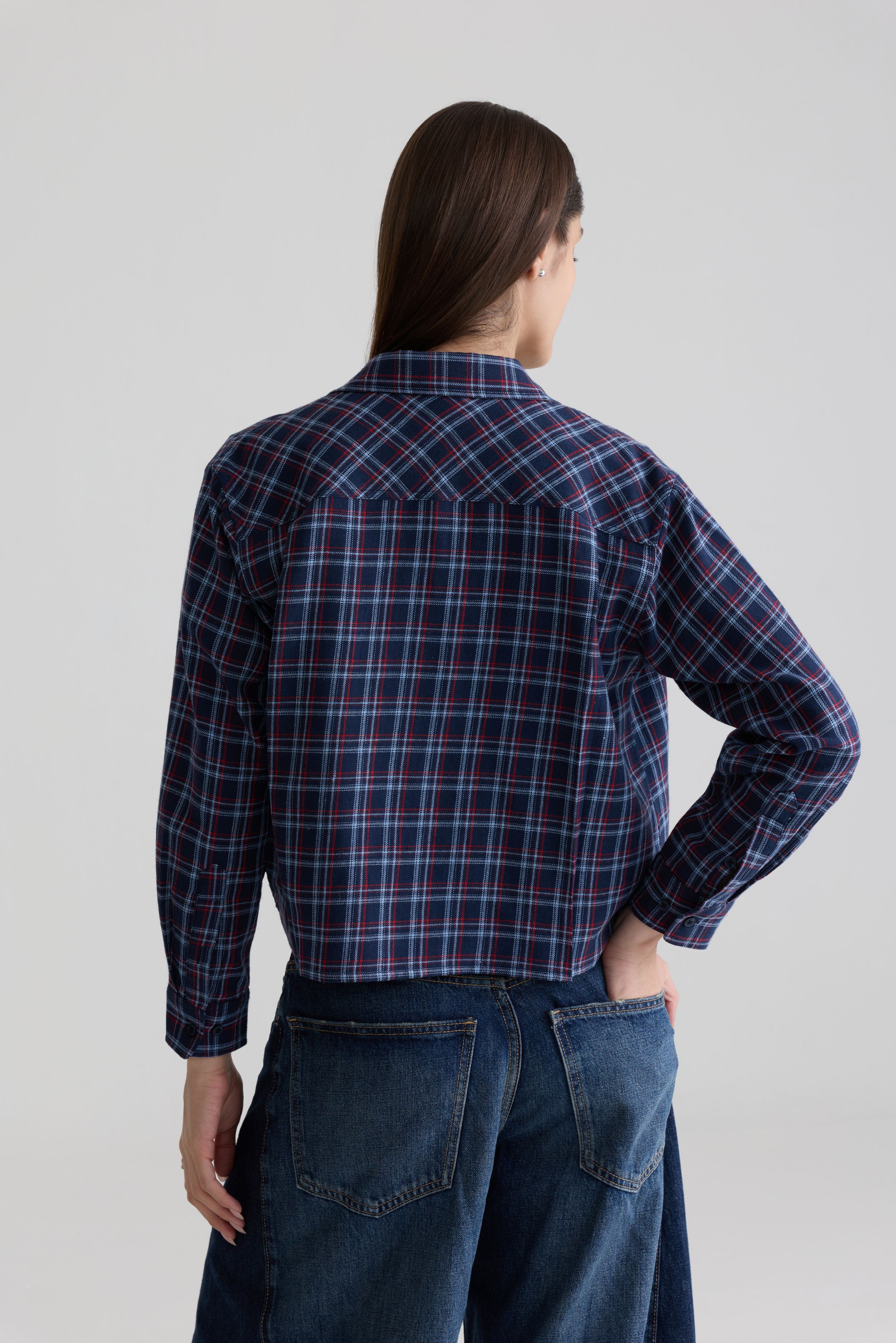 Model wearing blue women’s check flannel shirt — back view showing relaxed fit